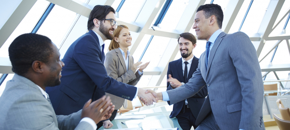 Group of business people congratulating their colleagues with striking grand deal